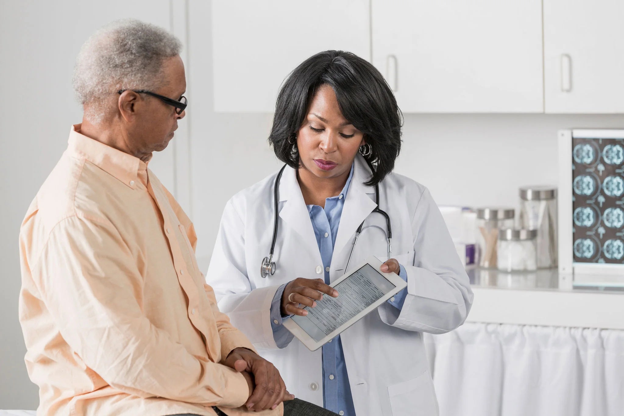 files/ey-african-american-doctor-showing-patient-digital-tablet.webp